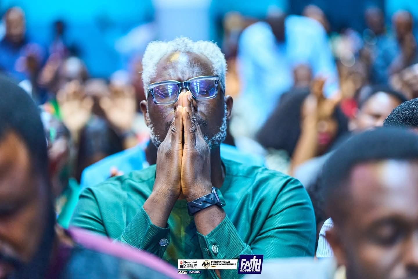 Evangelist Kesiena Esiri praying during a conference session